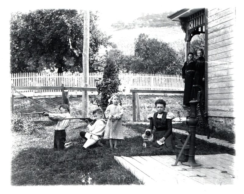 84.1.65 Women and Children in Front of House