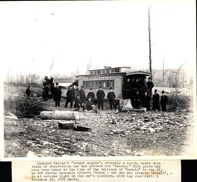 Passenger car of the Diamond Valley Railroad with passengers posing on and around the car and engine