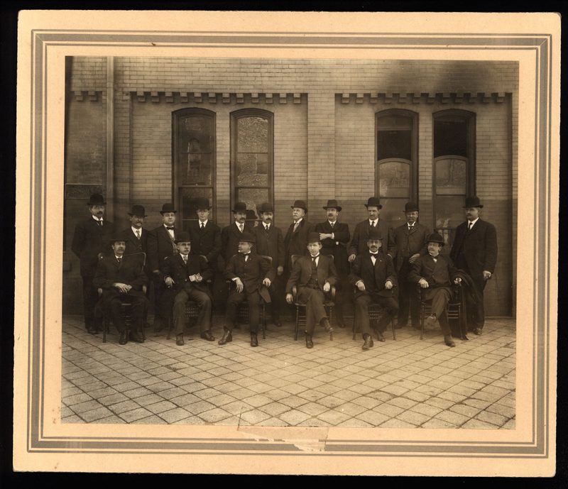 Members of Huntingdon County Medical Society, all in bowler hats, outside Railroad Station. Identified (all as Dr.): sitting - M.R. Evans, Huntingdon; G.G. Harman, Huntingdon; Chas. B. Bush, Orbisonia; W.A. Nason, ?; Howard C. Frontz, Huntingdon; Geo.W. Simpson, Mill Creek; standing - Wm. H. Sears, Huntingdon; Wm.J. Campbell, Mt. Union; John M. Steel, Huntingdon; John M. Beck, Alexandria; C.A.R. McClain, Mt. Union; Landon; Alvin R. McCarthy, Mt. Union; W.H. Boggs, Huntingdon; John C. Stever, Mt. Union; John C.  Fleming, Shirleysburg; J.M. Johnston, Huntingdon.    2 copies in same env.